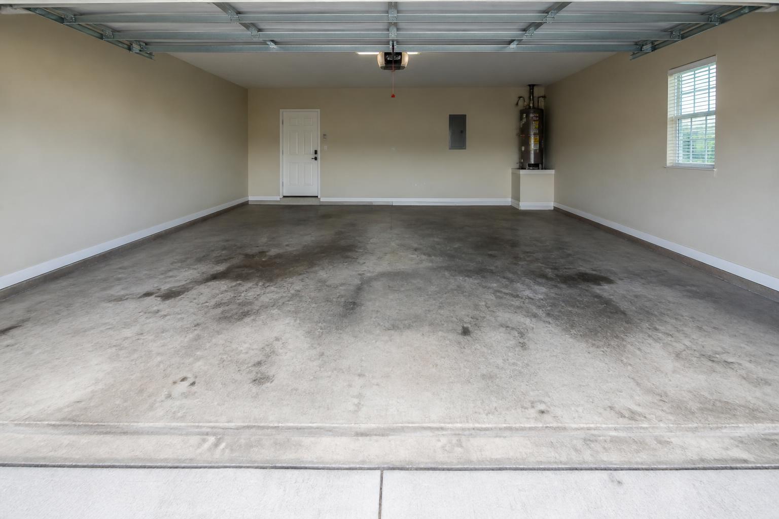 Dirty stained concrete garage floor before epoxy installation